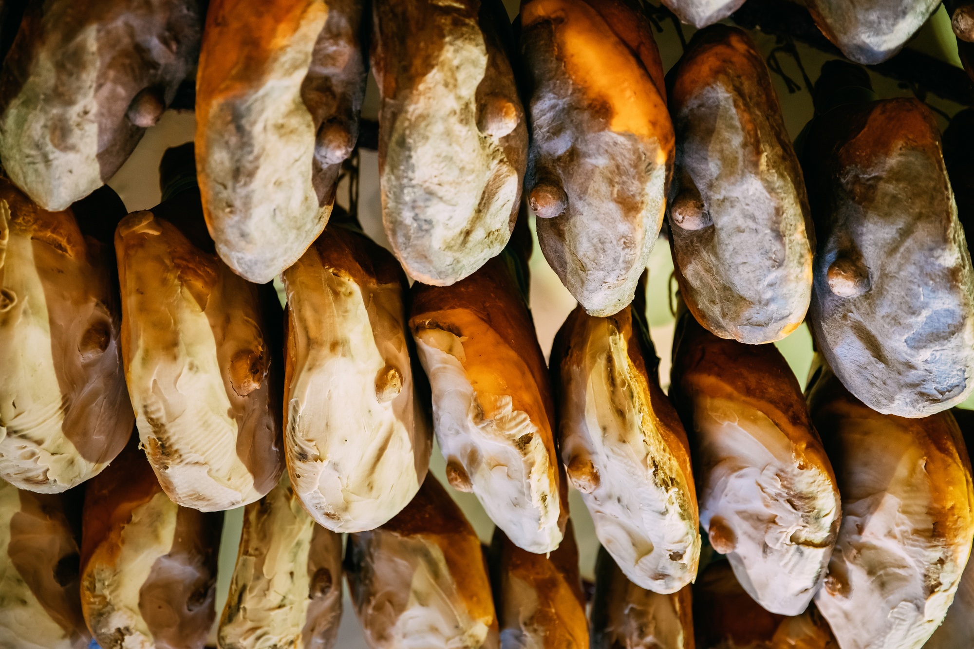 Hanging Italian Dry-cured Ham Prosciutto In Shop. Italian Cuisin